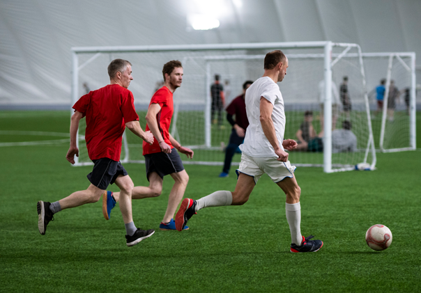 full-shot-men-playing-soccer